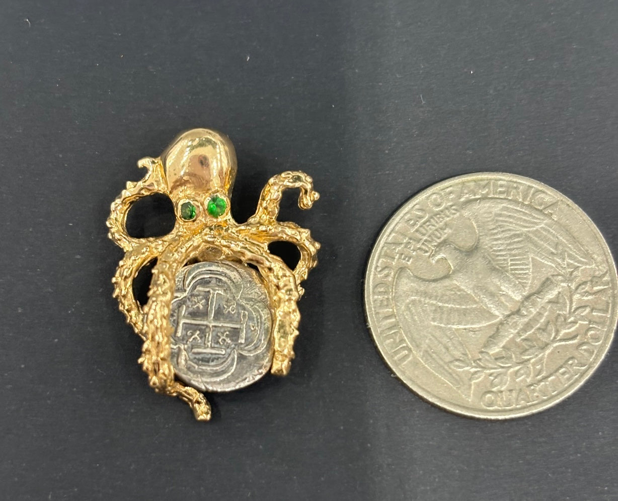 NUESTRA SENORA DE ATOCHA MINI SILVER COIN PENDANT IN 14KT SOLID GOLD OCTOPUS BEZEL WITH GREEN CRYSTAL EYES