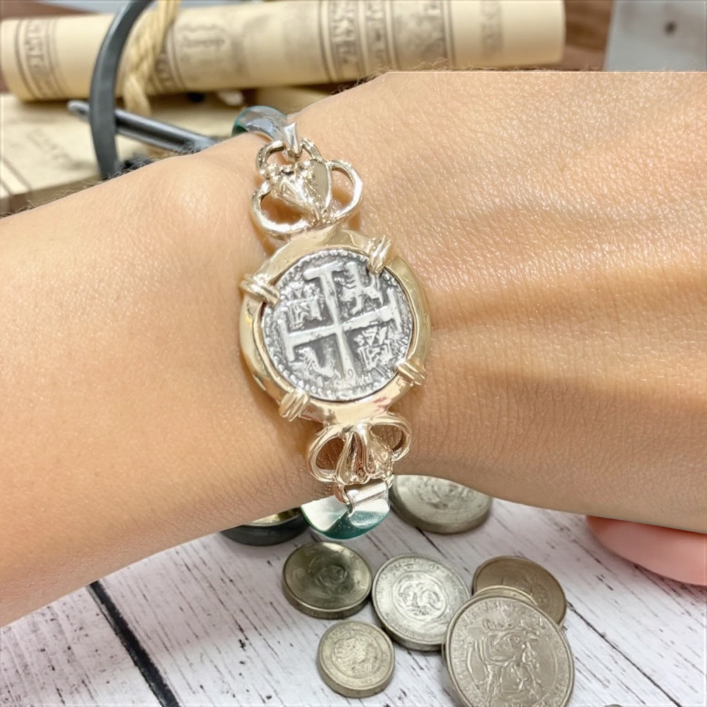 ATOCHA SOLID SILVER COIN BANGLE BEZELED WITH 14k SOLID GOLD BEZEL AND 14k SOLID GOLD CONCHS