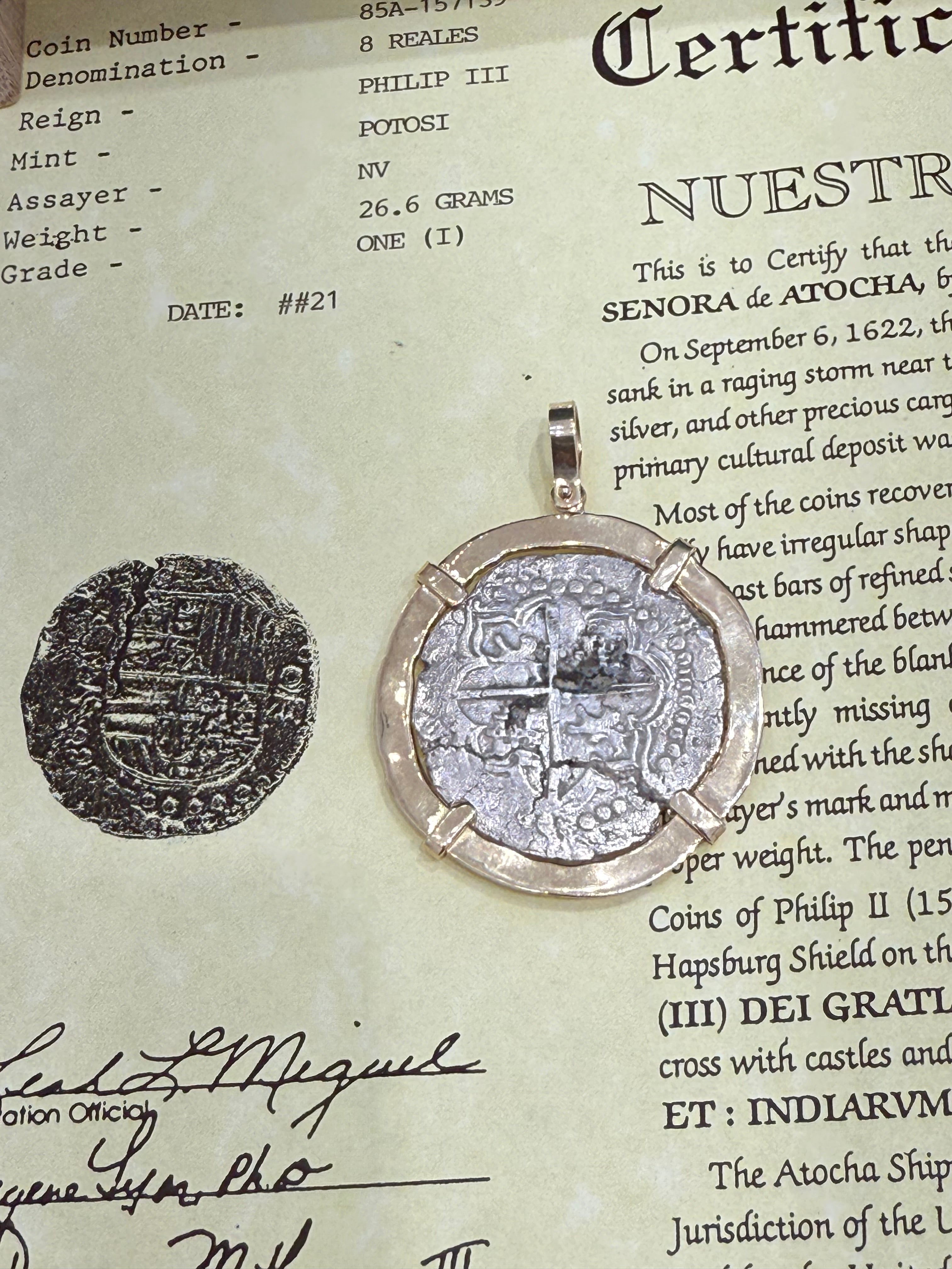 ACTUAL COIN NUESTRA SENORA DE ATOCHA SILVER COIN 8 REALE GRADE 1 COIN NO 85A-157139 DATED ##21 BEZELED WITH 14k SOLID GOLD