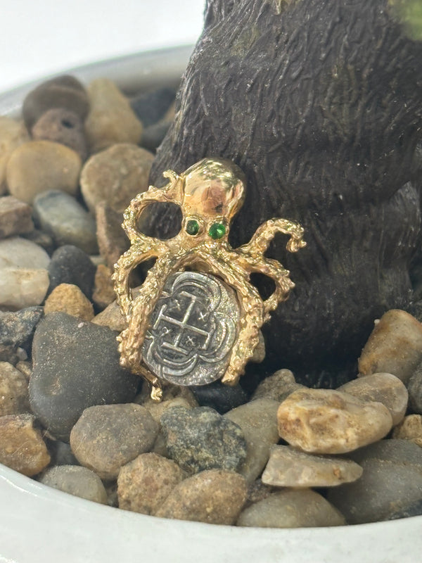 NUESTRA SENORA DE ATOCHA MINI SILVER COIN PENDANT IN 14KT SOLID GOLD OCTOPUS BEZEL WITH GREEN CRYSTAL EYES