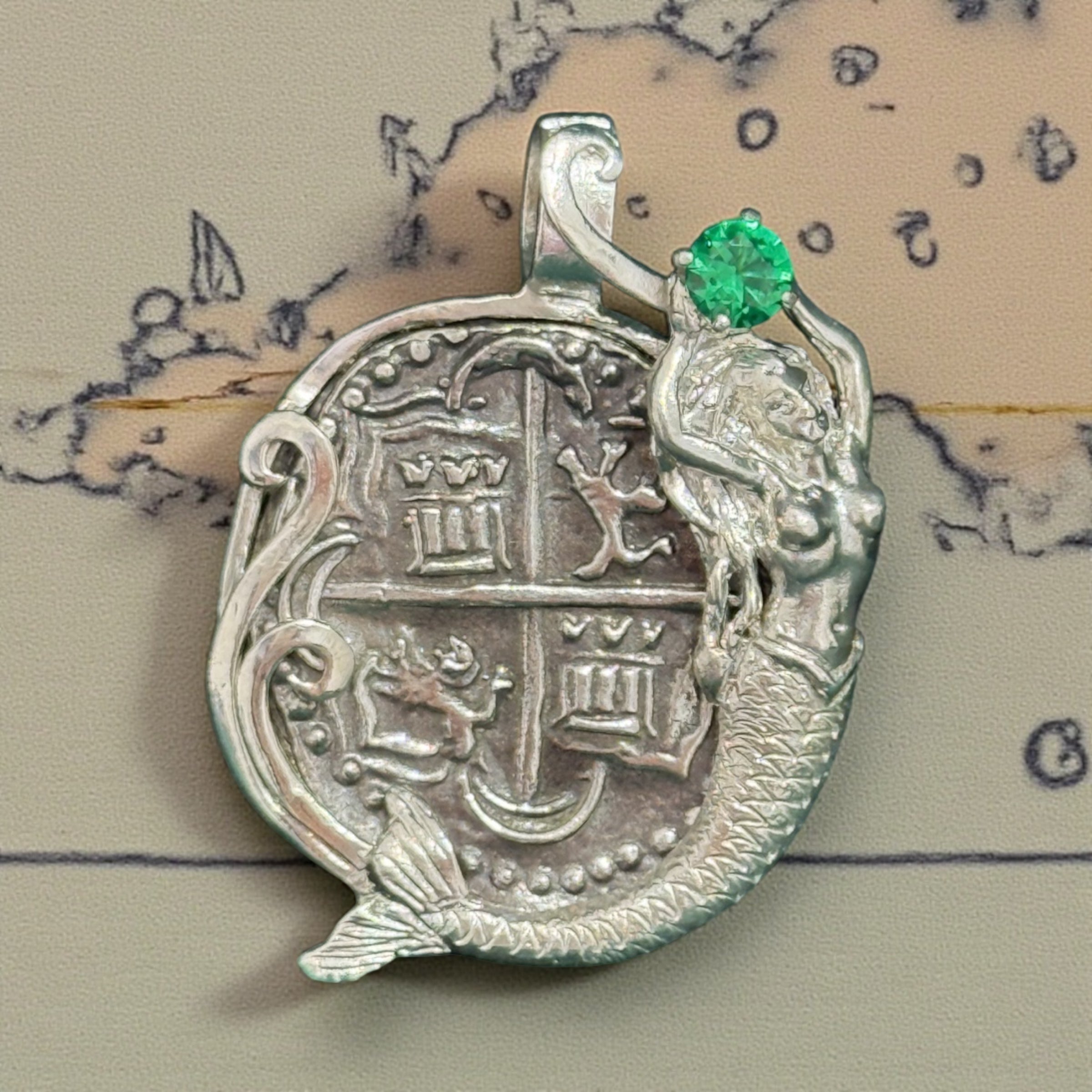 Atocha shipwreck silver coin pendant in mermaid bezel holding emerald