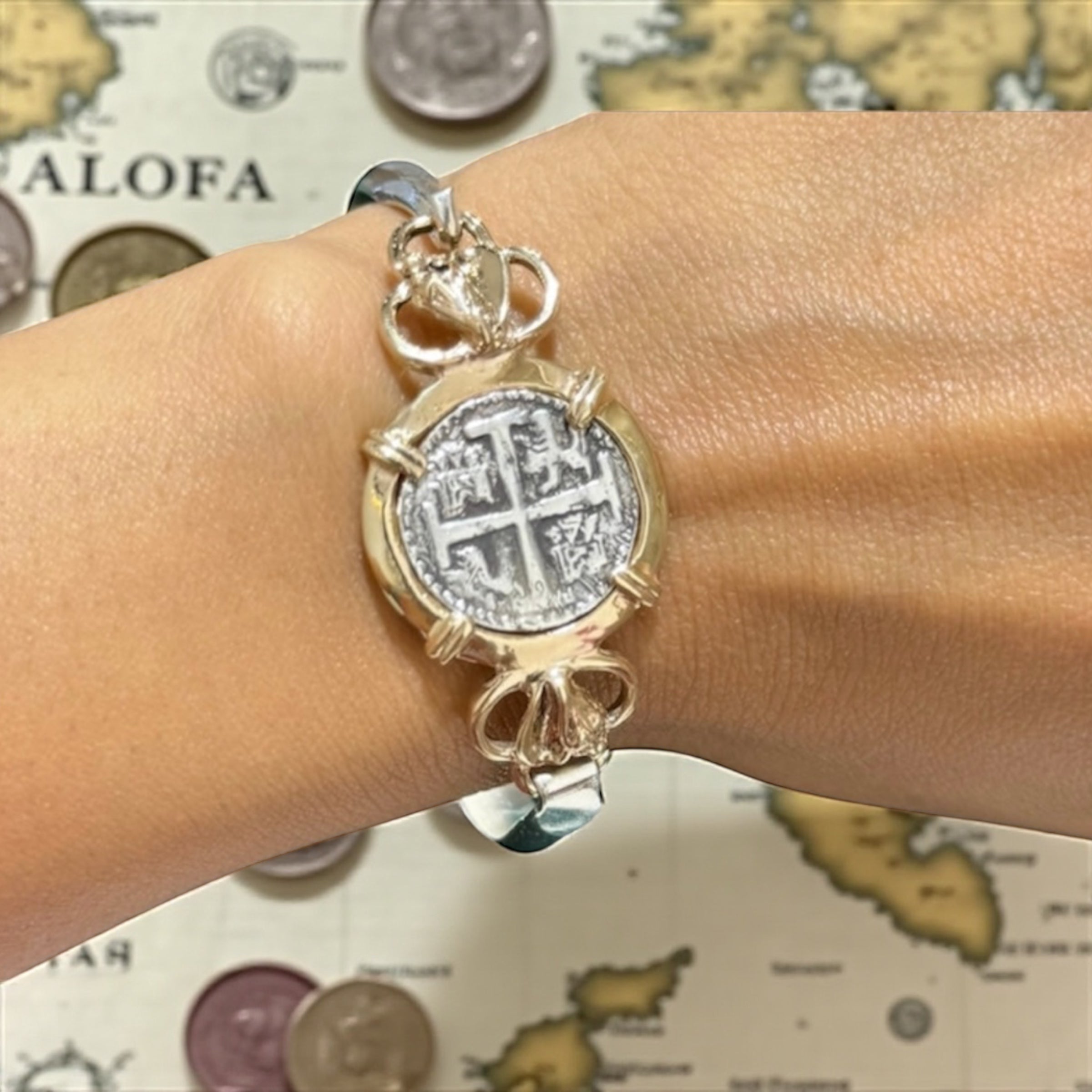 ATOCHA SOLID SILVER COIN BANGLE BEZELED WITH 14k SOLID GOLD BEZEL AND 14k SOLID GOLD CONCHS