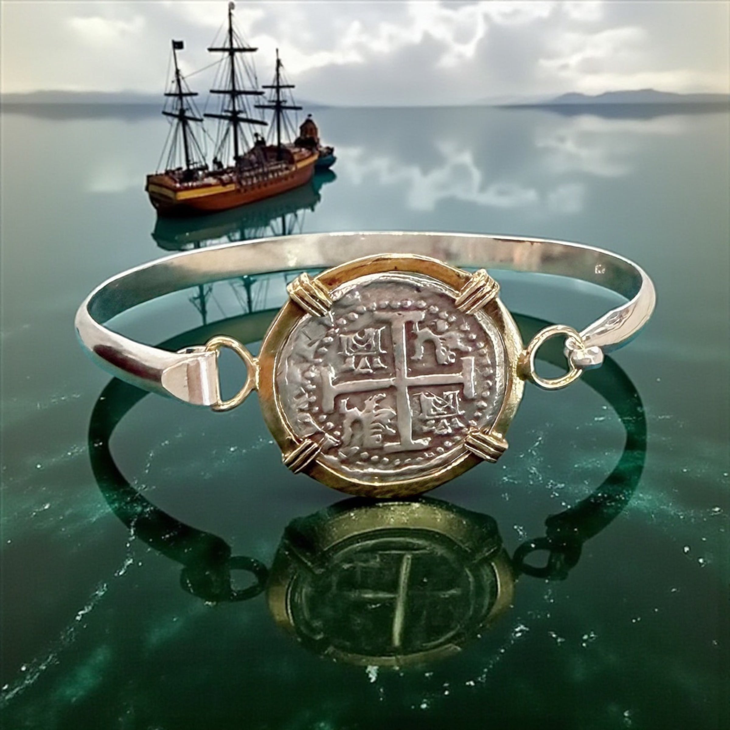 ATOCHA SOLID SILVER COIN BANGLE BEZELED WITH 14k SOLID GOLD BEZEL